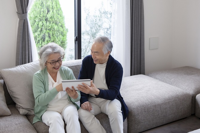 asian senior couple using a digital tablet at home
