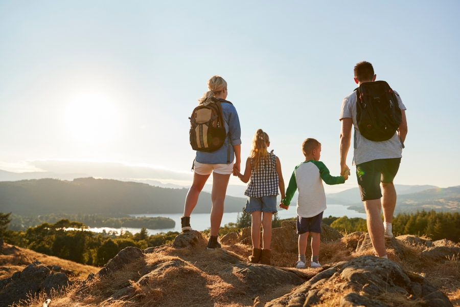 family hiking water hills