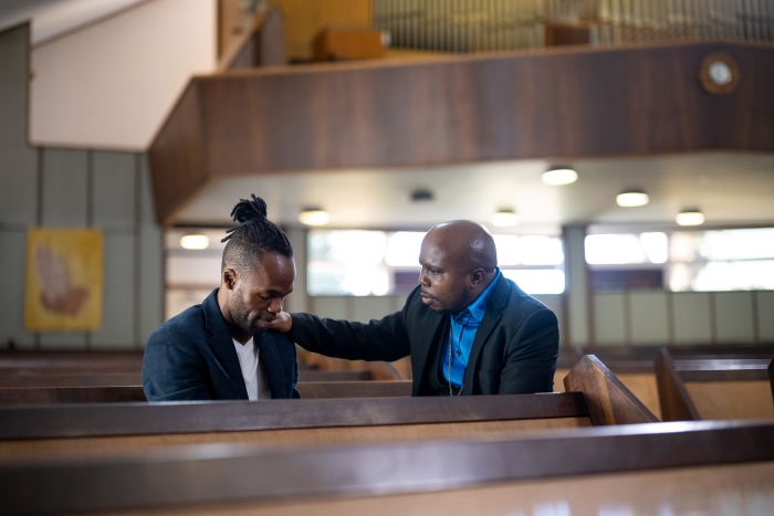 man counseling younger man church