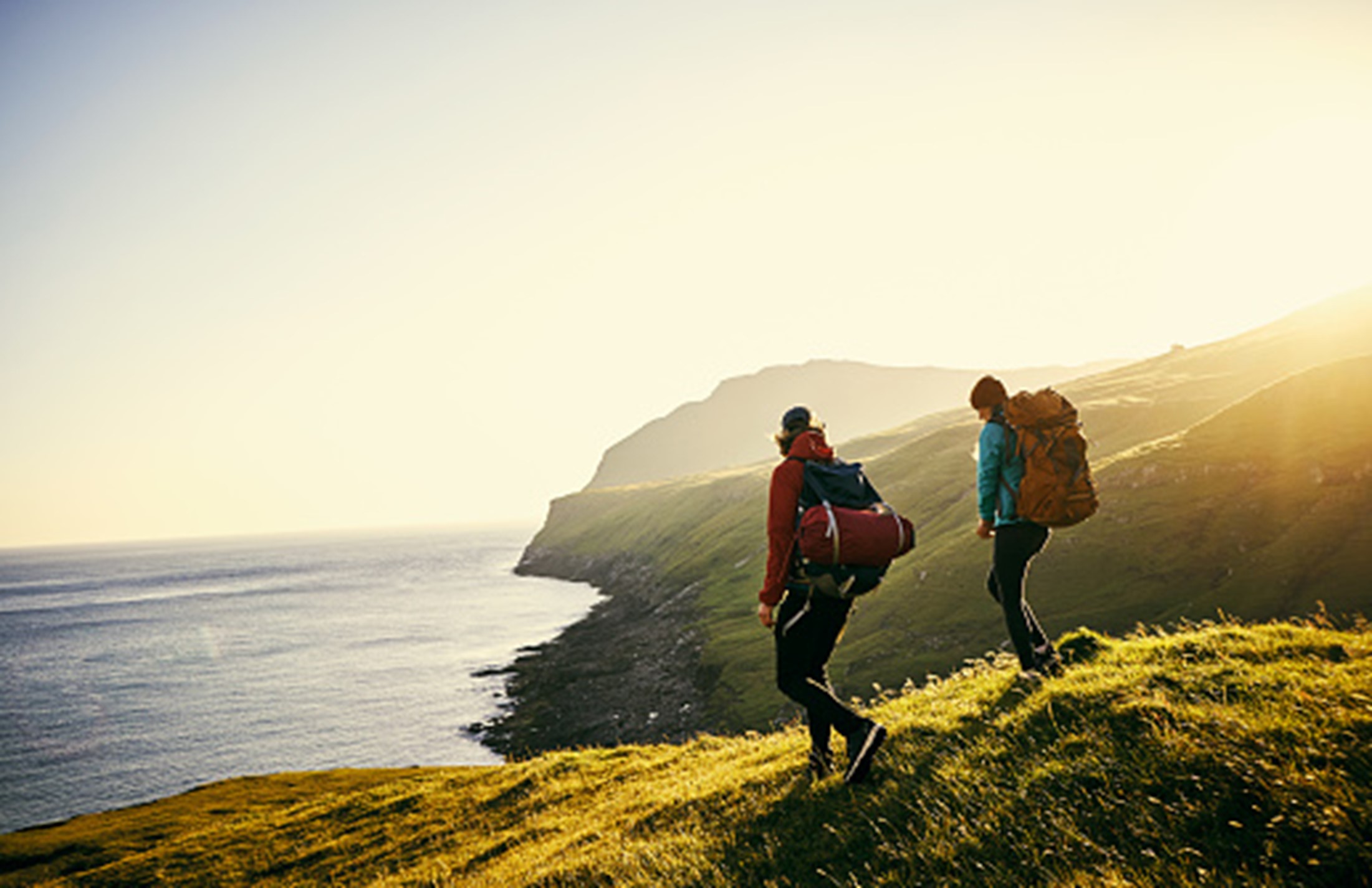 people hiking hills water