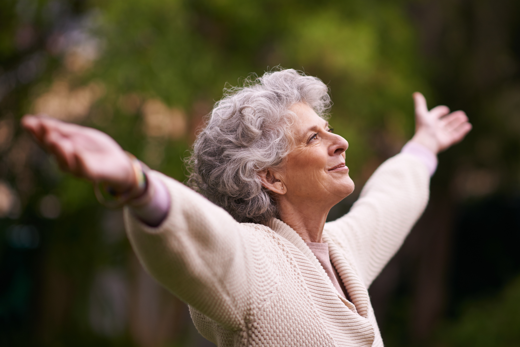 woman elderly arms raised